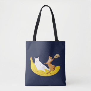 Cat chilling on banana holding hat tote bag