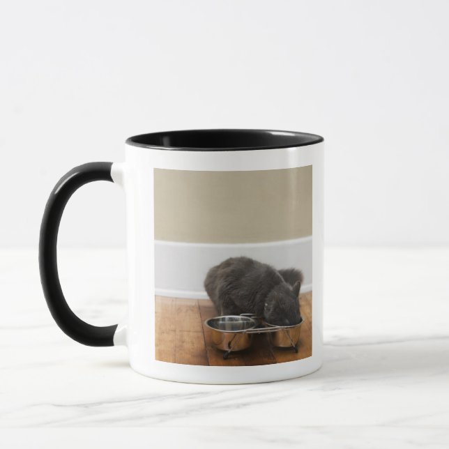 Cat eating from bowl mug (Left)