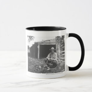 Cat eating out of a coffee can mug