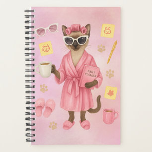 Cat female is holding daily planner