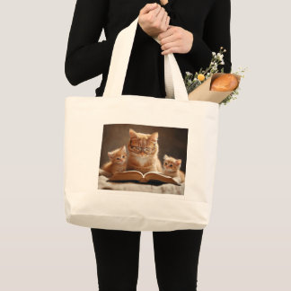 Cat in glasses reading a book to her kittens large tote bag