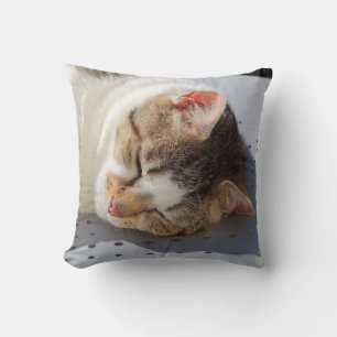 Cat sleeping in a garden throw pillow