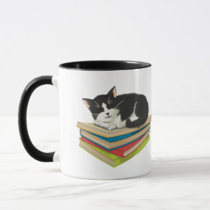 Cat sleeping on books mug