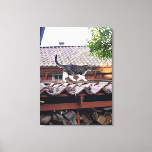 Cat walking on roof of shed canvas print