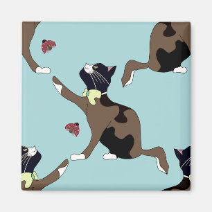 Cat with a bow catches a ladybug. magnet