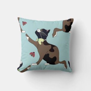 Cat with a bow catches a ladybug. throw pillow