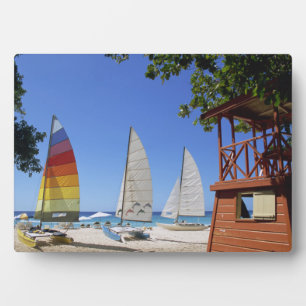 Catamarans And Lifeguard Stand On Beach Plaque