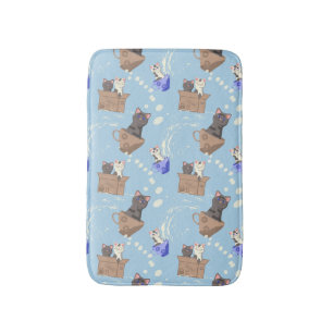 Cats in box and milk drops on blue bath mat
