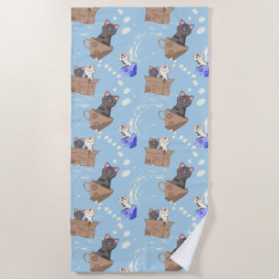Cats in box and milk drops on blue beach towel