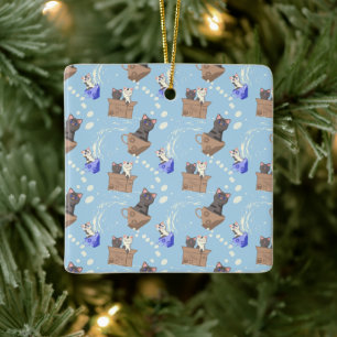Cats in box and milk drops on blue ceramic ornament