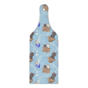 Cats in box and milk drops on blue cutting board