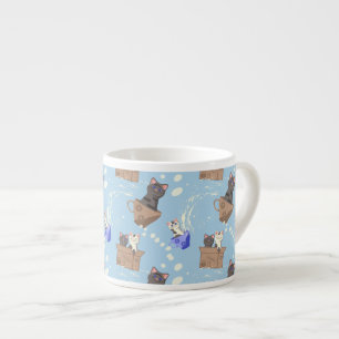 Cats in box and milk drops on blue espresso cup