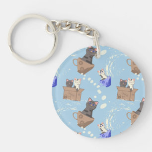 Cats in box and milk drops on blue keychain