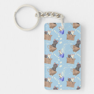 Cats in box and milk drops on blue keychain
