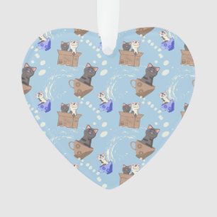 Cats in box and milk drops on blue ornament