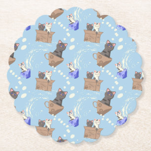 Cats in box and milk drops on blue paper coaster