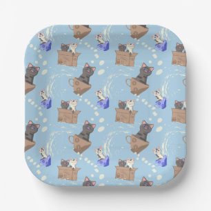 Cats in box and milk drops on blue paper plate
