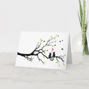 Cats in love with red hearts on spring tree card