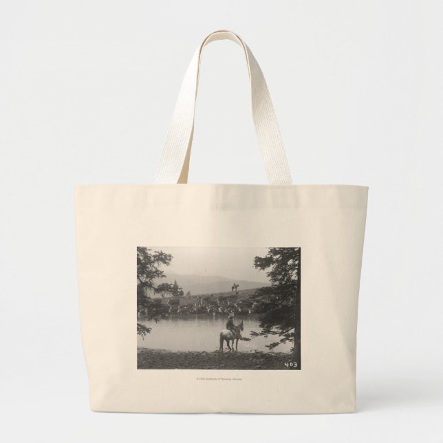 Cattle by a pond with two cowboys. large tote bag (Front)