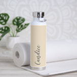 Champagne Personalized Wedding Bridesmaid Water Bottle<br><div class="desc">Gift your wedding bridesmaid or maid of honour with this trendy, vacuum Insulated water bottle that features her name in grey, stylized script on a champagne colour background designed to match your wedding colour scheme. Personalize bottle by editing and replacing name with your own as desired. Select your water bottle...</div>