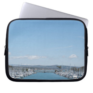 channel in harbour on a sunny day with blue sky laptop sleeve