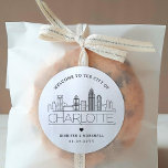 Charlotte Skyline | Wedding Welcome Message Classic Round Sticker<br><div class="desc">Enhance your wedding welcome packages or event party favours with a custom set of welcome stickers! These elegant yet minimal-style stickers are tailored for a wedding taking place in the beautiful city of Charlotte, North Carolina. They feature a modern deco skyline with the name of the city integrated underneath. All...</div>