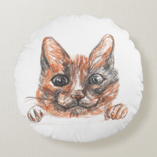 Chat dessinant autour du coussin de jet