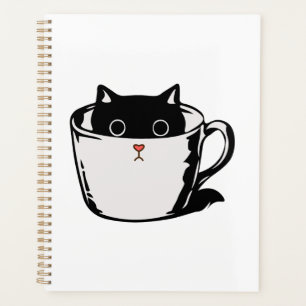 Chaton noir avec nez rouge caché dans une tasse