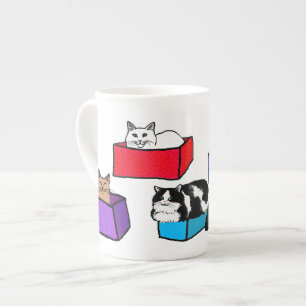 Chats dans la tasse colorée de porcelaine tendre