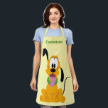Cheerful Pluto Puppy Graphic Apron<br><div class="desc">Brighten up your day with this endearingly expressive and joyful Pluto graphic! Featuring a front-facing, seated pose with a playful head tilt and a happy "tongue-out" expression, this design captures the essence of pure, friendly energy. The bold gold and orange tones are complemented by a vibrant green collar, creating a...</div>