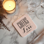 Cheers to Love Blush Black Wedding Square Paper Coaster<br><div class="desc">Romantic wedding coasters featuring "Cheers to Love" in bold mixed typography with elegant calligraphy accents and a delicate arrow detail on a soft blush pink background. A charming reception table accent or cocktail hour favour that celebrates the occasion with style. No personalization needed — ready to complement any wedding palette....</div>