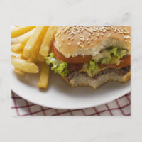 Cheeseburger, bites taken, with chips