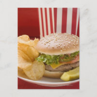Cheeseburger with potato crisps and gherkin