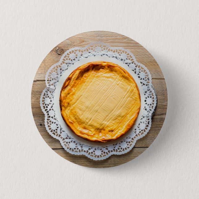 Cheesecake on rustic wood cake top. 2 inch round button (Front)