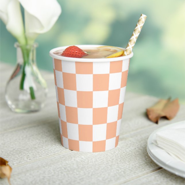 Chequered squares peach orange white geometric paper cups (Insitu)