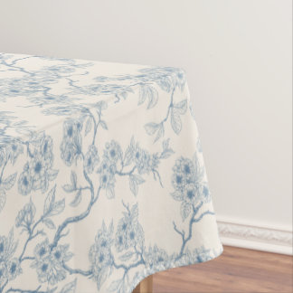 Chery blossom branches in blue and off white tablecloth