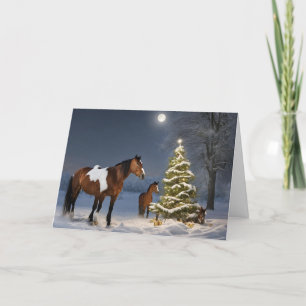 Chevaux dans la carte de voeux de Noël de neige