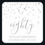 Chic 80th Birthday Party Silver Confetti Square Sticker<br><div class="desc">Help her celebrate her 80th birthday in style with this simple but elegant design, featuring faux silver triangular confetti sifting down on the word "eighty" in silver grey handwriting font on a white background. Personalize it with the name of the honoree in silver grey sans serif font, along with the...</div>