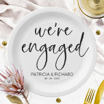 Chic Calligraphy We're Engaged Engagement Party Paper Plate<br><div class="desc">A stylish calligraphy engagement party paper plate. Easy to personalize with your details. CUSTOMIZATION: If you need design customization,  please contact me through chat; if you need information about your order,  shipping options,  etc.,  please get in touch with Zazzle support directly.</div>