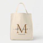 Chic Gold Monogram Script Names Wedding Date Tote Bag<br><div class="desc">Chic, modern gold monogrammed tote bag with your names and year established in black elegant hand lettered script calligraphy with a gold monogram. Simply add your names, monogram and year established beneath. Stylish design and perfect gift for the wedding guests of the newlywed couple. If you need any help or...</div>