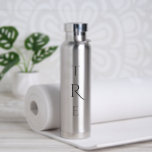 Chic Monogram on Silver Water Bottle<br><div class="desc">Chic black vertical monogram on silver features a larger more decorative initial in the centre. Replace the 3 initials with your own in the sidebar.
Other water bottle colours and styles available in the sidebar.
Copyright © Claire E. Skinner. All rights reserved.</div>