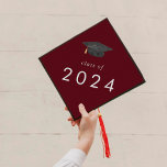 Chic Red Hat Class of 2024 Graduation Cap Topper<br><div class="desc">This chic red hat class of 2024 graduation cap topper is perfect for a modern graduation. The simple design features classic dark burgundy red and white typography with a black and gold watercolor graduation hat.

Personalize your graduation cap with the year.</div>