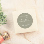 Chic Script Merry Christmas Lettering Green Classic Round Sticker<br><div class="desc">Bring a stylish touch to your holiday season with these stickers! Featuring "merry christmas" in elegant white script lettering and your family name in bold white sans serif typography, this sticker is perfect for adding a personal touch to gifts, envelopes, or holiday cards. Use it to seal packages, decorate gift...</div>