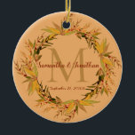 Chic Terracotta Foliage Monogram Wedding Keepsake Ceramic Ornament<br><div class="desc">Here's a stunning wedding keepsake gift for the newlyweds to hang on their Christmas tree. This design features an elegant rustic eucalyptus foliage wreath in earthy autumn shades of sage green, yellow and red encircling the last name initial monogram of the bride and groom together with their first names and...</div>