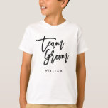 Chic Trendy Brush Black Script Team Groom T-Shirt<br><div class="desc">T-shirt featuring the words "Team Groom" in chic trendy brush black script that's perfect for the ring bearer. For other matching items see here https://www.zazzle.com/collections/119250194970828530?rf=238364477188679314 Personalize it by replacing the placeholder text. For more options such as to change the font and it's size, colour or the spacing between letters click...</div>