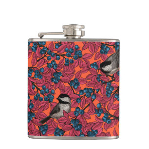 Chickadee birds on blueberry branches on orange hip flask