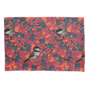 Chickadee birds on blueberry branches on orange pillowcase