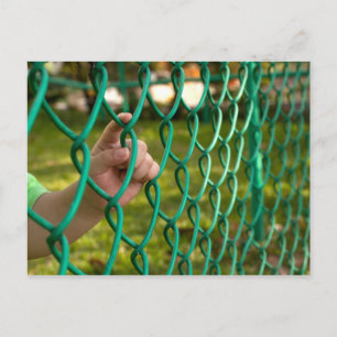 Child finger on fence postcard