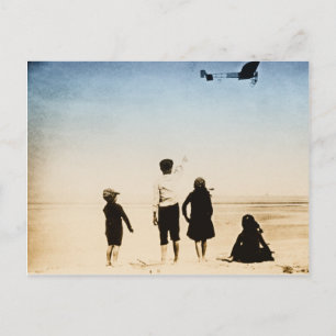 Children watching airplane on the beach postcard