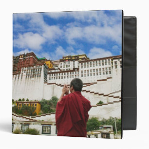 China, Tibet, Lhasa, Tibetan monk with Potala Binder